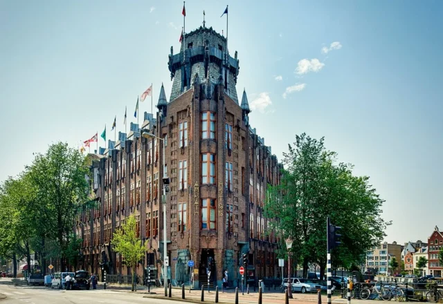 Landmark historic hotel featuring an imposing brick façade, distinctive tower and ornate architectural details near Amsterdam’s waterfront, Grand Hotel Amrâth Amsterdam, Amsterdam.