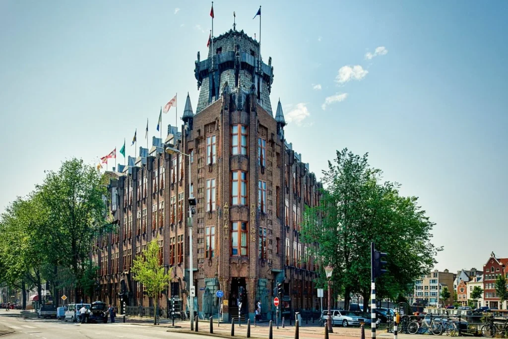 Landmark historic hotel featuring an imposing brick façade, distinctive tower and ornate architectural details near Amsterdam’s waterfront, Grand Hotel Amrâth Amsterdam, Amsterdam.