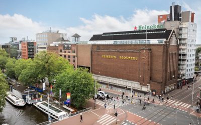 Historic Heineken brewery building beside the canal and busy city streets at Heineken Experience, Amsterdam