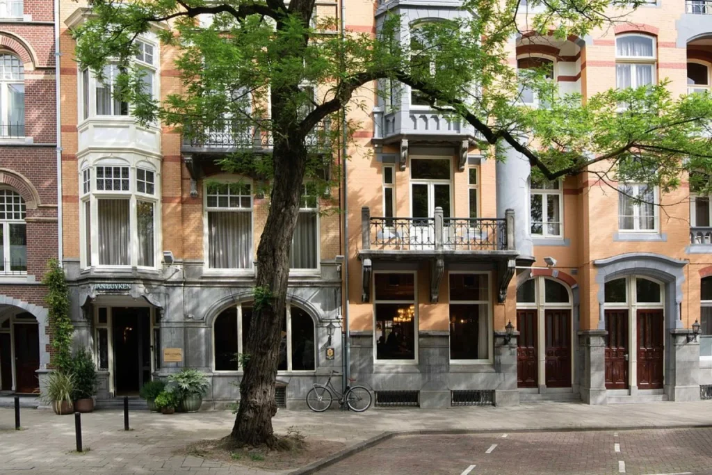 Charming townhouse exterior framed by mature trees in Amsterdam’s Museum Quarter, Jan Luyken Amsterdam