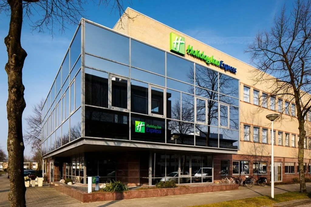Modern exterior of Holiday Inn Express Amsterdam with a glass-fronted facade in Amsterdam