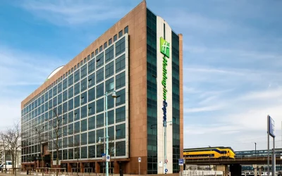Modern hotel exterior beside the railway tracks and station at Holiday Inn Express Amsterdam – Sloterdijk Station, Amsterdam