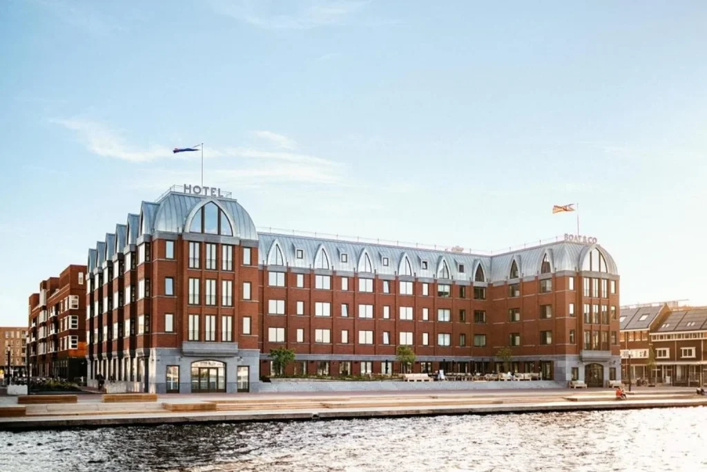 Waterfront exterior of Hotel BOAT & CO Amsterdam overlooking the IJ