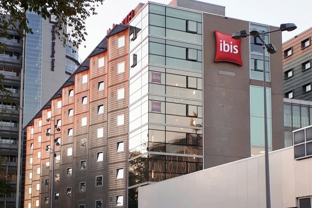 Modern hotel exterior with a large bicycle parking area beside Amsterdam Central Station at Ibis Amsterdam Centre