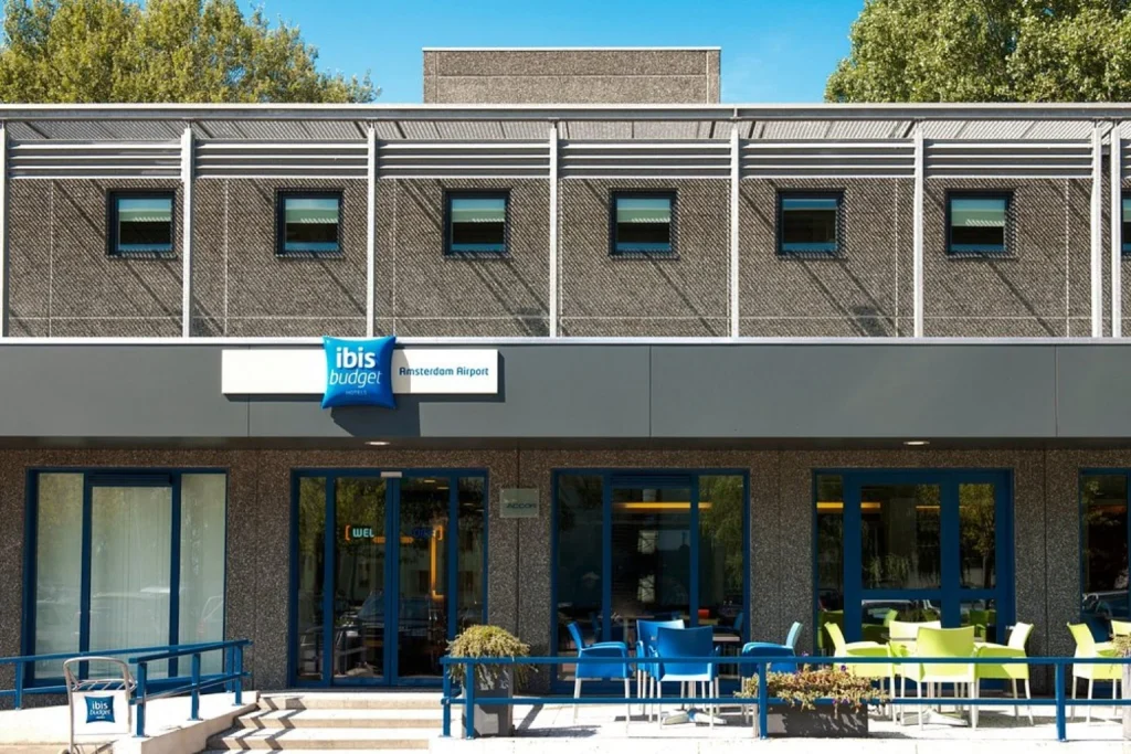 Budget airport hotel exterior with outdoor seating and modern façade at ibis budget Amsterdam Airport in Amsterdam