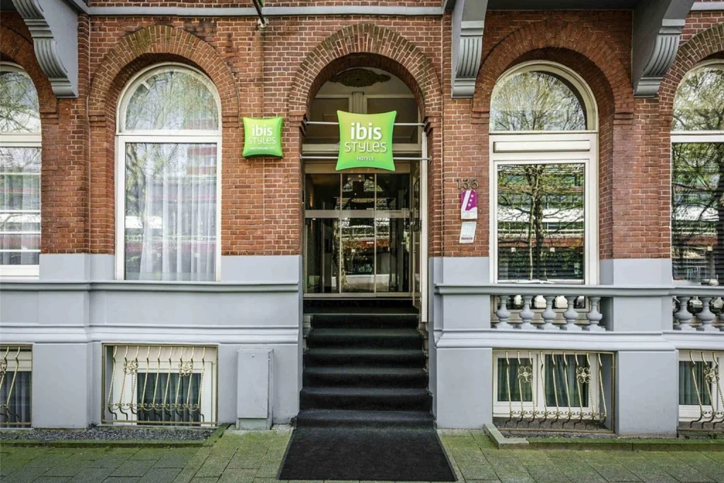 Historic brick facade and main hotel entrance at ibis Styles Amsterdam City, Amsterdam