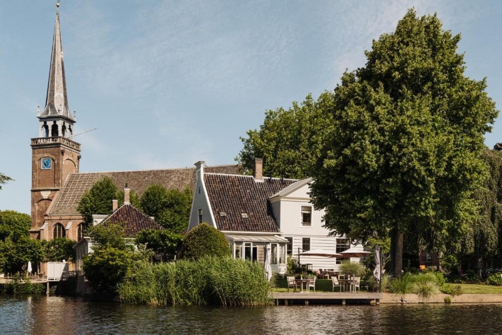 Peaceful waterfront boutique hotel surrounded by lush gardens and traditional Dutch village scenery at Inn on the Lake in Broek in Waterland.