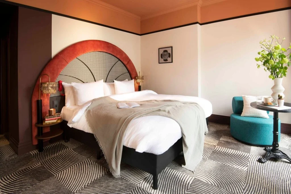 Elegant boutique hotel room with king bed and stylish interior at Jan Luyken Amsterdam, Amsterdam