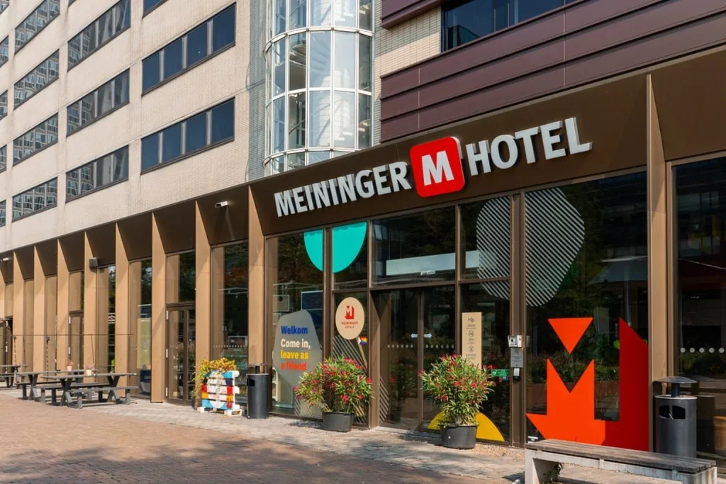 Colorful modern hotel entrance conveniently located near Amsterdam Sloterdijk Station at MEININGER Hotel Amsterdam City West, Amsterdam