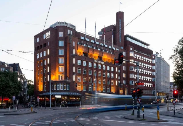 Historic brick hotel exterior near tram lines and Leidseplein at NH Amsterdam Leidseplein, Amsterdam, Netherlands
