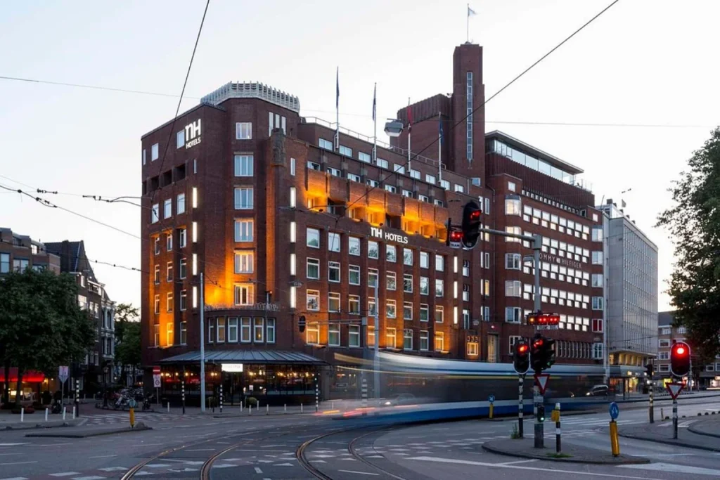 Historic brick hotel exterior near tram lines and Leidseplein at NH Amsterdam Leidseplein, Amsterdam, Netherlands