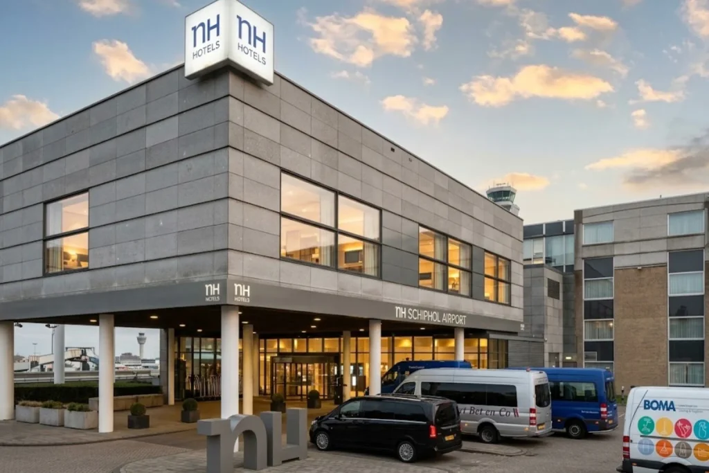 Modern airport hotel exterior with main entrance and Schiphol terminal in the background at NH Schiphol Airport in Amsterdam