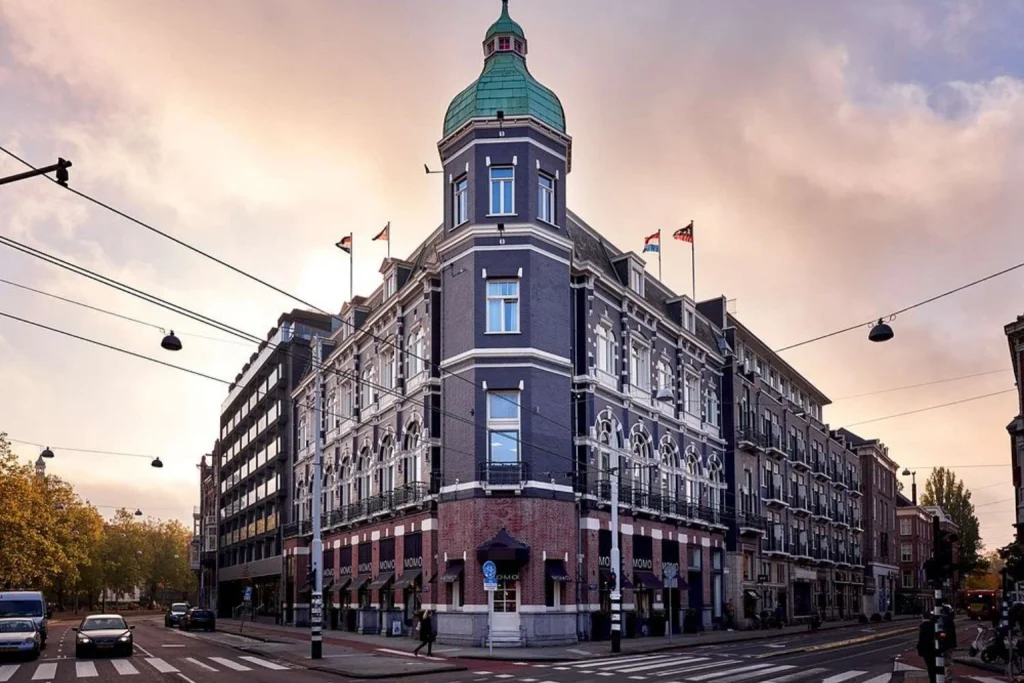 Elegant historic façade with a prominent corner tower and classic architectural details at Park Centraal Amsterdam, Amsterdam
