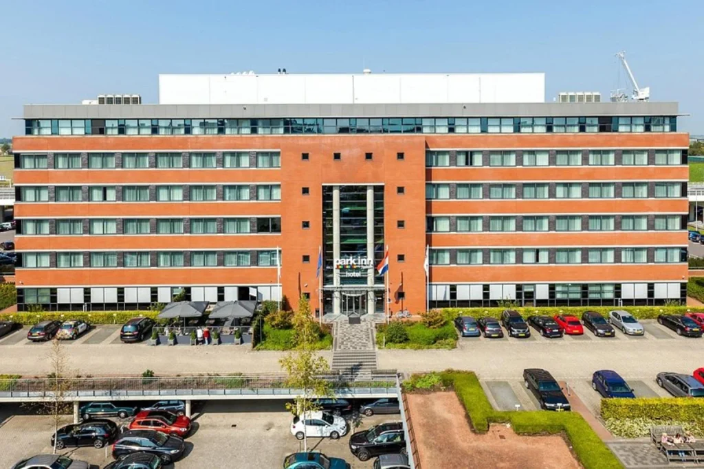 Airport hotel exterior with large brick facade, main entrance and parking at Park Inn by Radisson Amsterdam Airport in Amsterdam