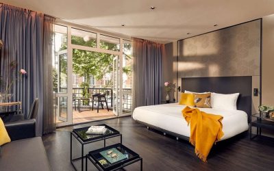 Contemporary guest room with a king bed, elegant seating area and private balcony at Park Plaza Vondelpark, Amsterdam