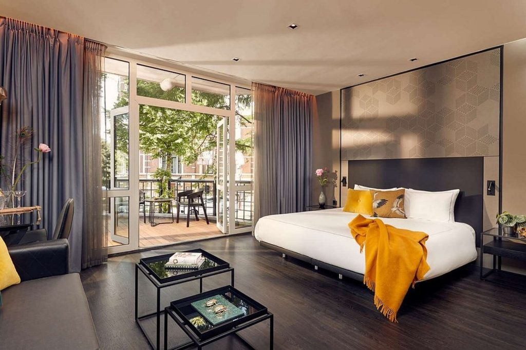 Contemporary guest room with a king bed, elegant seating area and private balcony at Park Plaza Vondelpark, Amsterdam