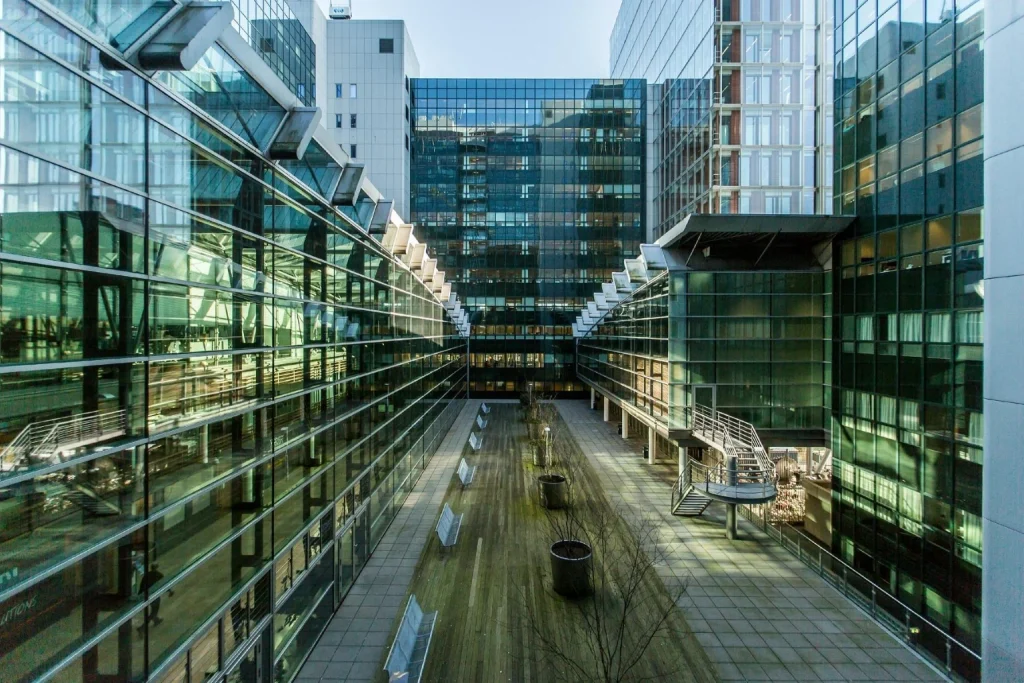 Contemporary glass buildings and open courtyard surrounding Qbic Hotel Amsterdam WTC in Amsterdam