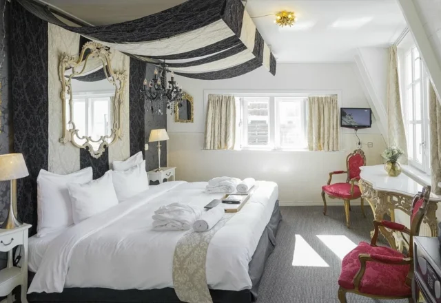 Characterful guest room with dramatic fabrics, antique-style furnishings and elegant decorative details, Rosalia’s Menagerie Inn, Amsterdam