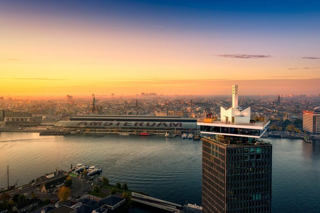 Panoramic sunset view of Sir Adam Hotel (A’DAM Tower), Amsterdam waterfront and city skyline