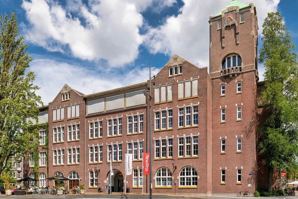 Impressive historic brick building with a landmark tower and classic Amsterdam architecture at Stayokay Amsterdam Pijp, Amsterdam