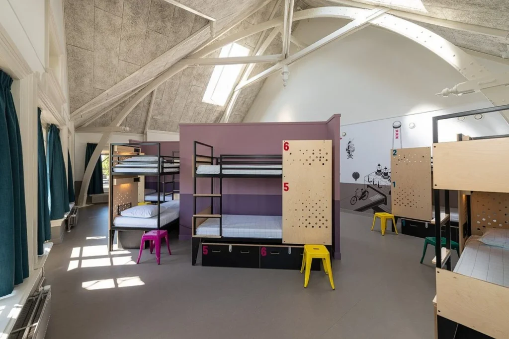 Bright shared dormitory with modern bunk beds and spacious interiors at Stayokay Hostel Vondelpark, Amsterdam