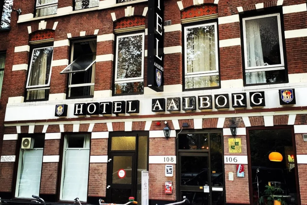 Distinctive brick facade and main entrance of the gaming-themed hotel at The Arcade Hotel, Amsterdam