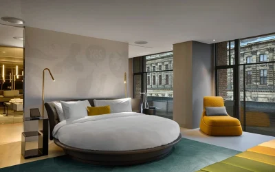 Modern luxury hotel room with round bed, floor-to-ceiling windows and contemporary interior at W Amsterdam, Amsterdam, Netherlands