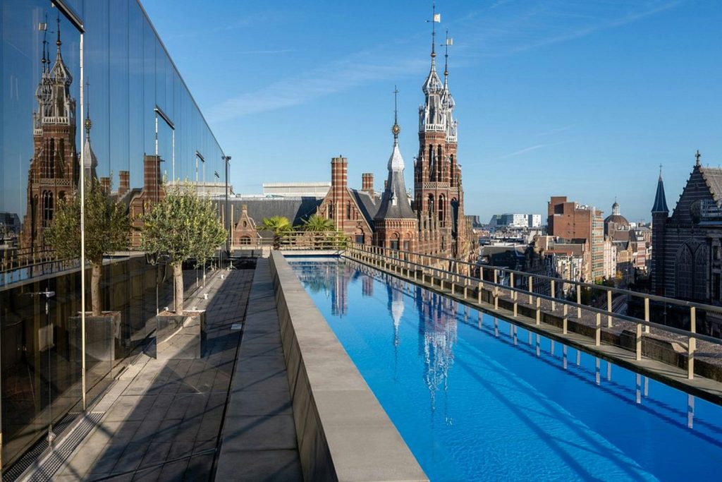 Rooftop pool at W Amsterdam overlooking the city’s historic rooftops and landmark architecture.